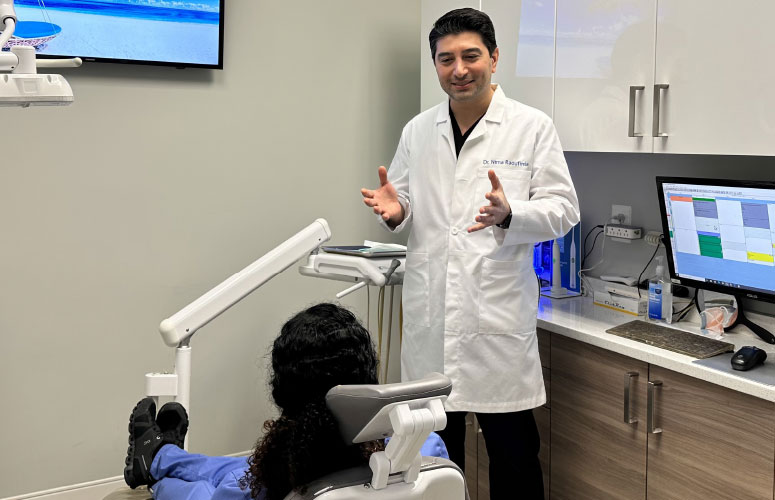 Dr. Nima Raoufinia with a patient.